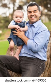 Handsome Hispanic Father And Son Posing For A Portrait In The Park.