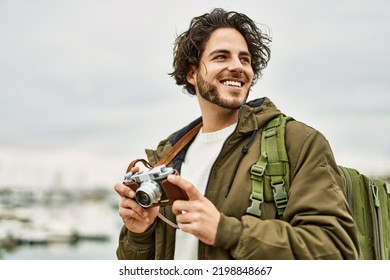 Handsome Hispanic Man Using Vintage Camera By Marina Port