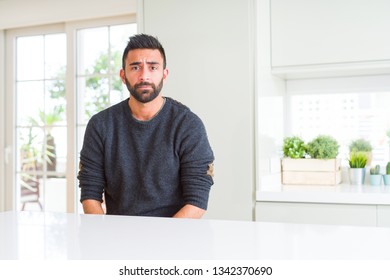 Handsome hispanic man wearing casual sweater at home depressed and worry for distress, crying angry and afraid. Sad expression. - Shutterstock ID 1342370690