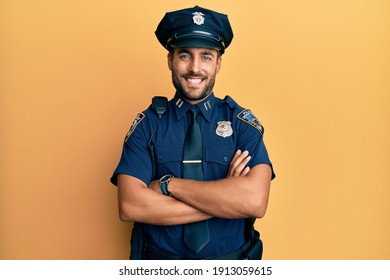 Handsome Hispanic Man Wearing Police Uniform Happy Face Smiling With Crossed Arms Looking At The Camera. Positive Person. 