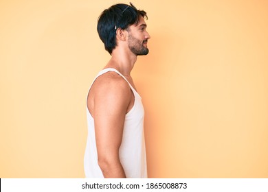 Handsome Hispanic Man Wearing Summer Look And Sunglasses Looking To Side, Relax Profile Pose With Natural Face With Confident Smile. 