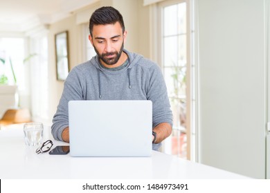 Handsome Hispanic Man Working Using Computer Laptop With A Confident Expression On Smart Face Thinking Serious