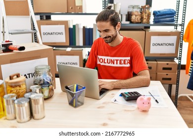 Handsome hispanic man working as volunteer doing countability at donation stand - Shutterstock ID 2167772965
