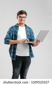 Handsome Indian / Asian Male Student Using Laptop, Isolated On White Background
