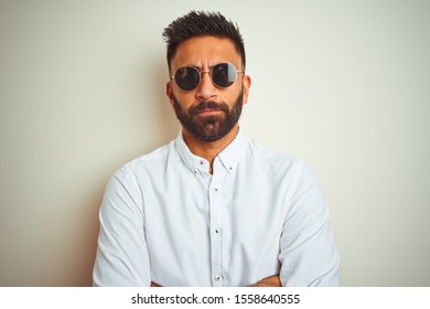 Handsome Indian Buinessman Wearing Shirt And Sunglasses Over Isolated White Background Skeptic And Nervous, Disapproving Expression On Face With Crossed Arms. Negative Person.