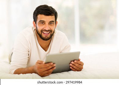 Handsome Indian Man Holding Tablet Computer At Home