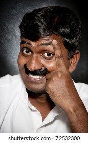 Handsome Indian Man With Moustache And Raise Eyebrow Smiling And Looking At Camera Close-up