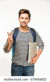 Handsome Indian/Asian Male College Student Standing With Laptop Computer, Against White Background, Isolated