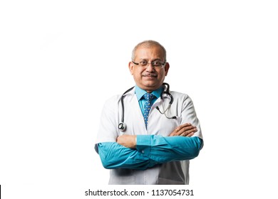 Handsome Indian/asian Senior Doctor Or Physician With Stethoscope, Uniform.  Writing On Chart, Checking MRI Or Using Smartphone