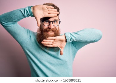 Handsome Irish redhead man with beard wearing glasses over pink isolated background Smiling cheerful playing peek a boo with hands showing face. Surprised and exited