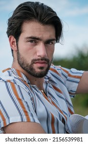 Handsome Italian Dark-haired Guy With Striped Shirt. High Quality Photo