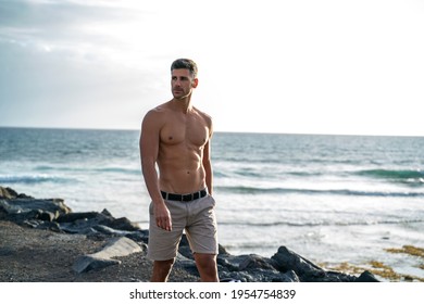 Handsome Italian Man Posing Shirtless On The Beach. Muscular Man Outdoor. Summer Vibes. 