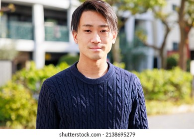 Handsome Japanese man smiling at the camera - Powered by Shutterstock