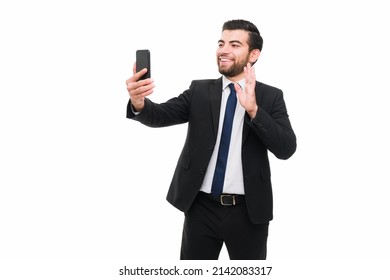 Handsome Lawyer Having A Video Call With His Family While Working At A Law Firm. Businessman Having A Video Call On His Smartphone