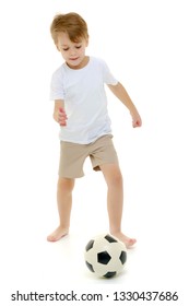 Handsome Little Boy In A Pure White T-shirt Playing With A Soccer Ball. On The T-shirt, You Can Make An Advertising Inscription Of A Football Club, Or Apply Any Other Inscription. Isolated On White