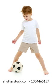 Handsome Little Boy In A Pure White T-shirt Playing With A Soccer Ball. On The T-shirt, You Can Make An Advertising Inscription Of A Football Club, Or Apply Any Other Inscription. Isolated On White