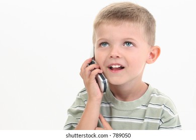 Handsome Little Four Year Old Boy Speaking On Cellphone.  Shot In Studio Over White.