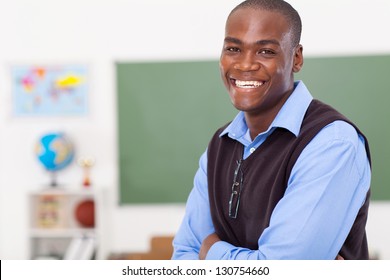 Handsome Male African Primary School Teacher In Classroom