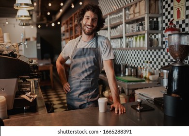 Handsome Male Barista Is Working In Coffee Shop