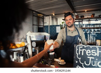 handsome male barrister serving woman freshly made hot coffee in funky cafe  - Powered by Shutterstock