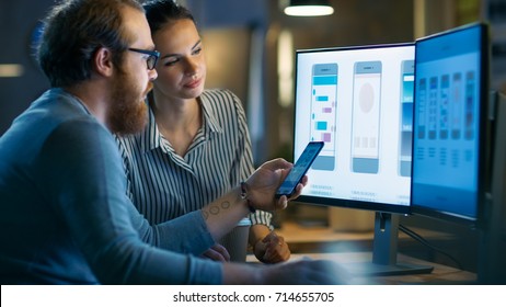 Handsome Male and Beautiful Female Mobile Application Designers Test and Discuss New App Features. They Work on a Personal Computer, in a Creative Office Space they Share with Other Talented People. - Shutterstock ID 714655705