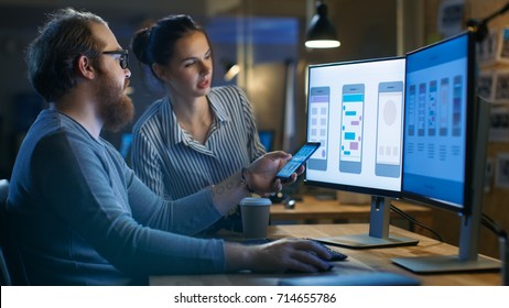Handsome Male and Beautiful Female Mobile Application Designers Test and Discuss New App Features. They Work on a Personal Computer, in a Creative Office Space they Share with Other Talented People. - Shutterstock ID 714655786
