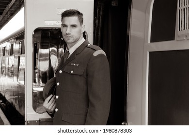 Handsome Male British Soldier In Vintage Uniform Standing By Train, Looking Sad Or Serious.