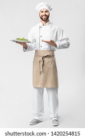 Handsome Male Chef With Salad On White Background