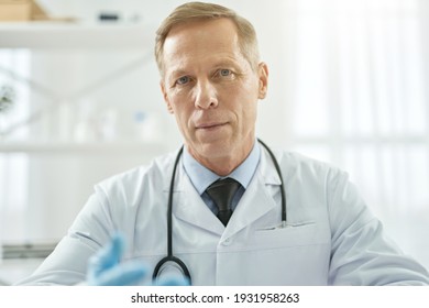 Handsome Male Doctor Posing Against White Background