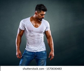 Handsome Male Fitness Model Wearing Jeans and White T-Shirts
