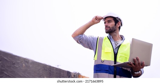 Handsome Male foreman engineer wearing helmet controls and maintains the operation project system using laptop on the background train garage.Banner cover design industrial team ,leadership concept. - Shutterstock ID 2171663895