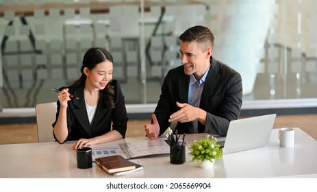 Handsome Male Health Insurance Broker Presenting His Health Insurance Benefits To Successful Businesswoman.