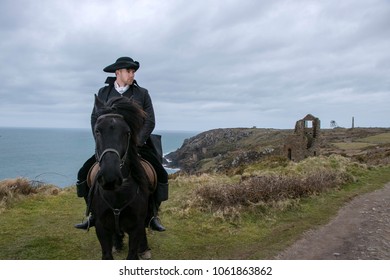 Handsome Male Horse Rider Regency 18th Century Poldark Costume with tin mine ruins and Atlantic ocean in background