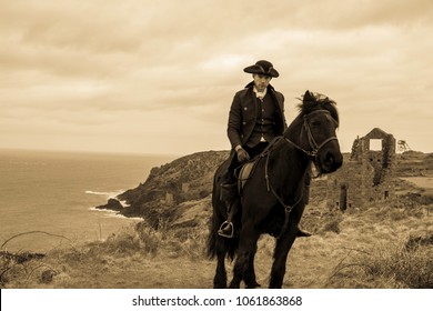 Handsome Male Horse Rider Regency 18th Century Poldark Costume with tin mine ruins and Atlantic ocean in background