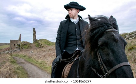 Handsome Male Horse Rider Regency 18th Century Poldark Costume with tin mine ruins and countryside in background