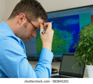 Handsome Male Meteorologist In Glasses Thinking.