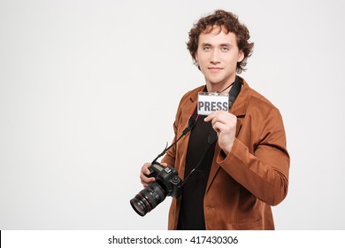 Handsome male reporter holding card with the word press isolated on a white background - Powered by Shutterstock