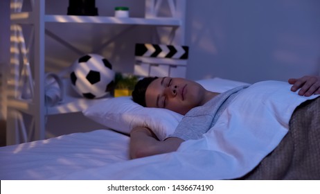 Handsome male teenager sleeping peacefully early in morning, promising boy - Powered by Shutterstock