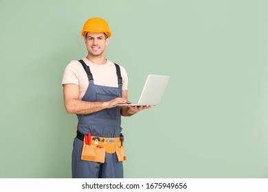 Handsome Male Worker With Laptop On Color Background