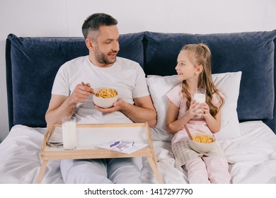 Handsome Man With Adorable Daughter Having Breakfast In Bed On Fathers Day Together