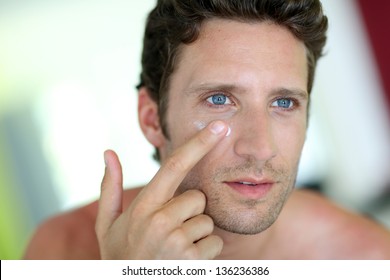 Handsome Man Applying Moisturizing Cream