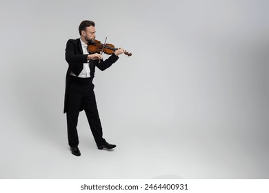 Handsome man artist playing violin - Powered by Shutterstock