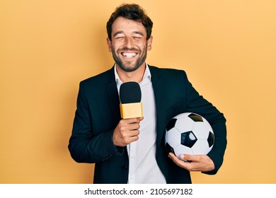 Handsome man with beard football reporter microphone smiling and laughing hard out loud because funny crazy joke. 