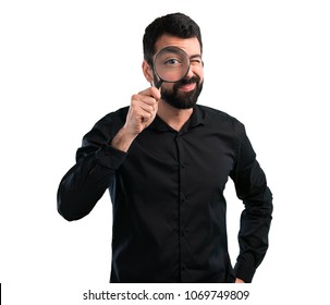 Handsome Man With Beard With Magnifying Glass On White Background