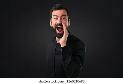 Handsome Man With Beard Shouting On Black Background