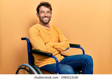 Handsome man with beard sitting on wheelchair happy face smiling with crossed arms looking at the camera. positive person. 
