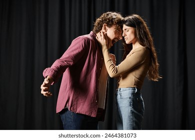 A handsome man and a beautiful woman rehearsing on a theater stage. - Powered by Shutterstock