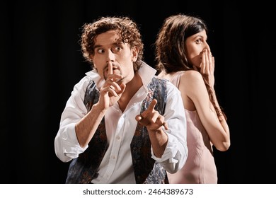 A handsome man and a beautiful woman stand side by side, poised and focused during theater rehearsals. - Powered by Shutterstock