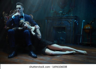 Handsome man and beautiful young woman in the style of the 1920s. Fashion clothes, make-up and hair in luxurious retro style. - Shutterstock ID 1696106038