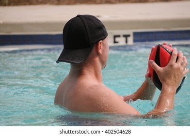 Handsome Man From Behind Throwing Football In Pool.